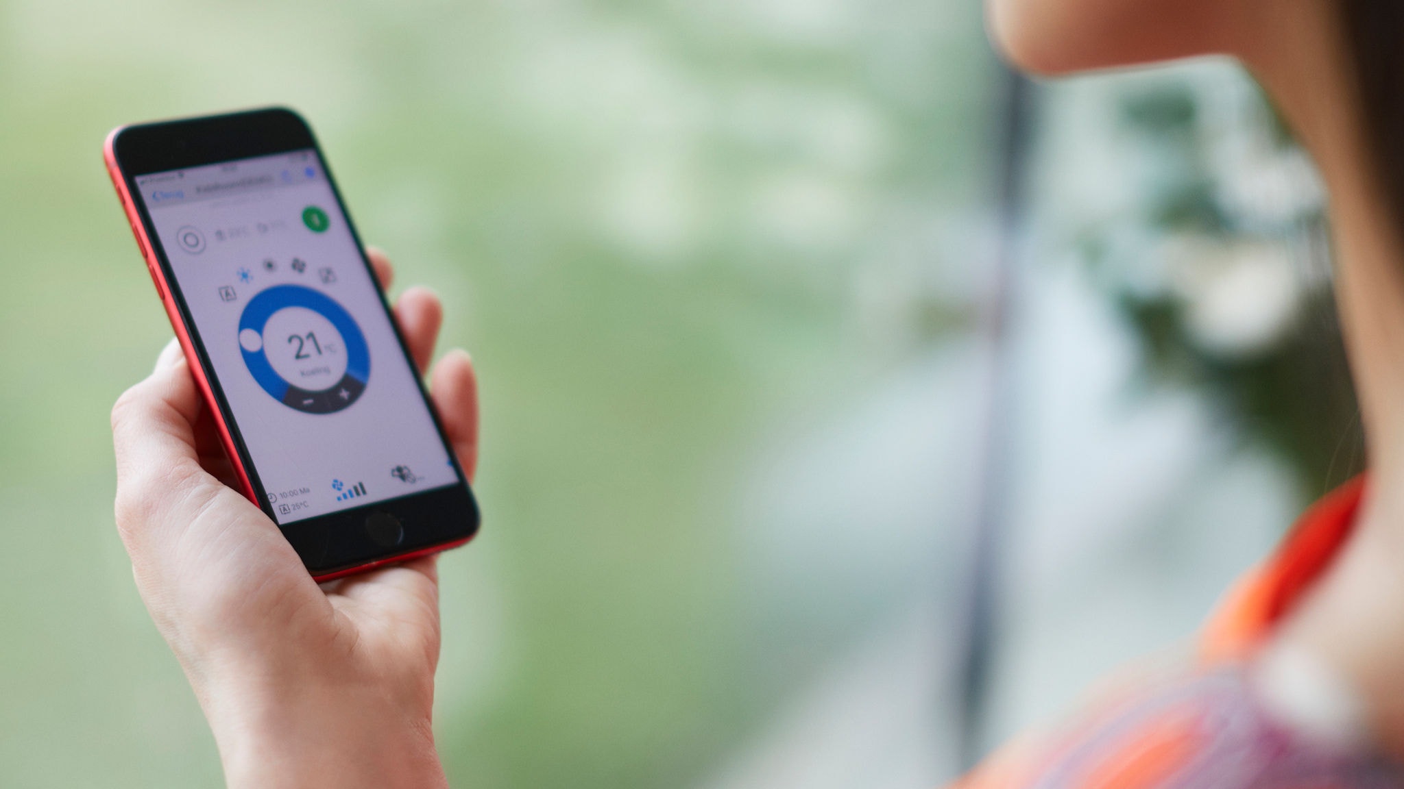 Femme utilisant une application pour commander sa solution de chauffage