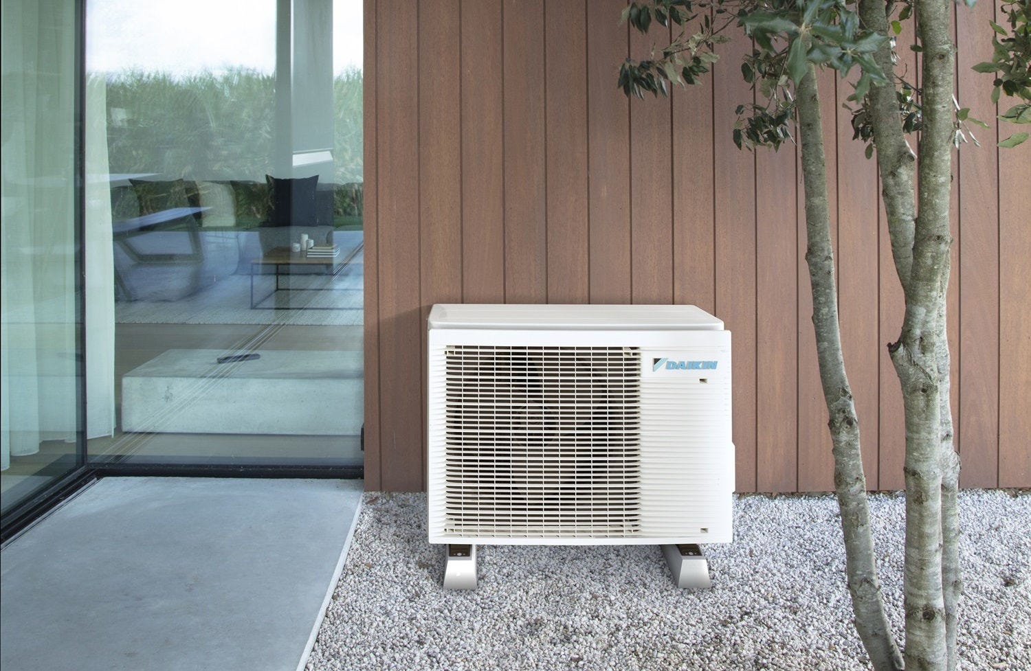Installer checking air source heat pump outdoor unit and hot water tank